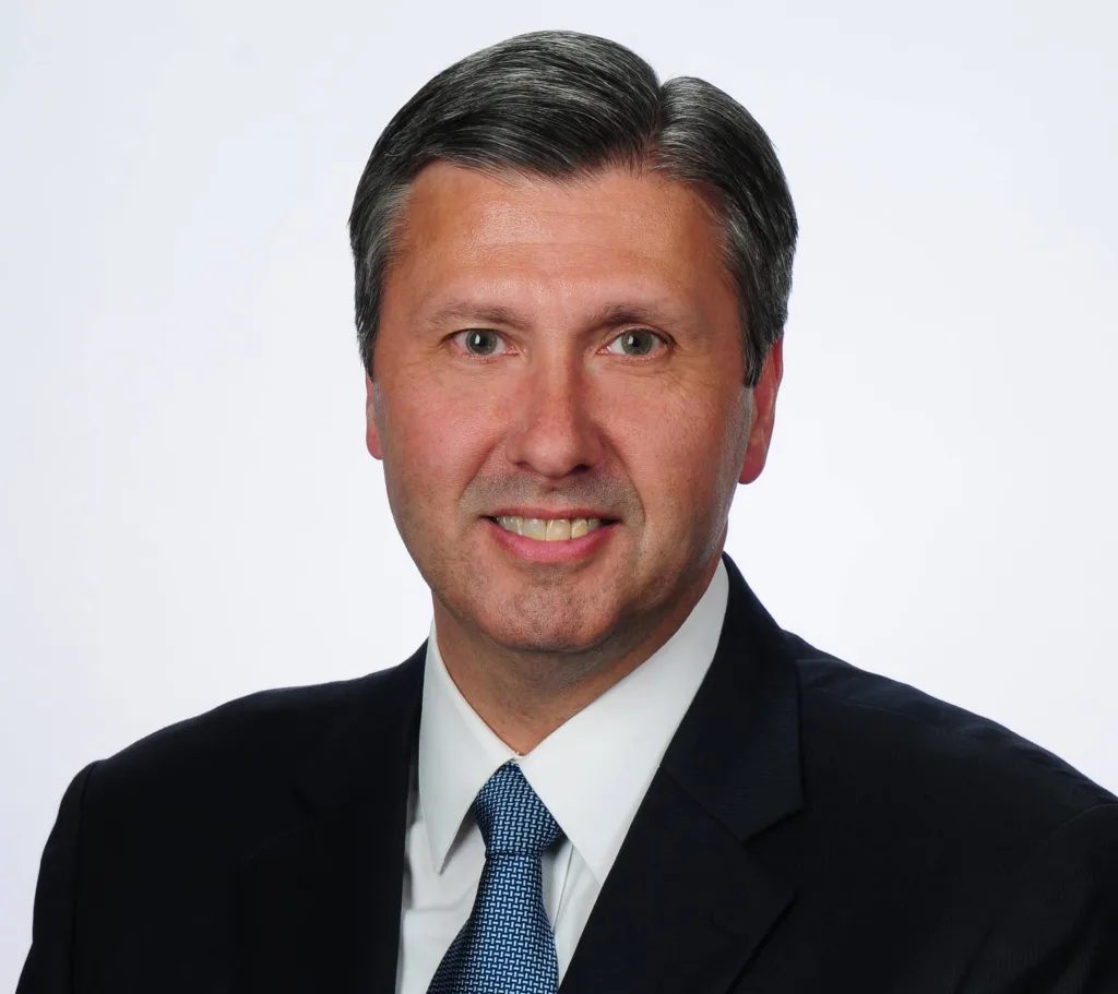 Doug Sanders, executive vice president of CBI Bank & Trust, smiles in a professional headshot. He is retiring Jan. 5 after 28 years with the bank.