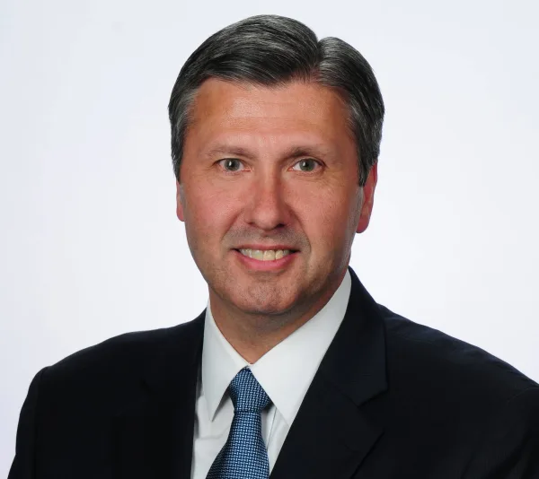Doug Sanders, executive vice president of CBI Bank & Trust, smiles in a professional headshot. He is retiring Jan. 5 after 28 years with the bank.