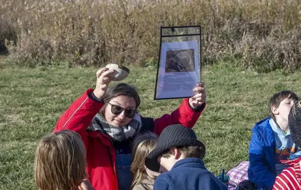 Teacher Natalie Brown with students at Bluestem Hall Nature School in Urbana during an outdoor class on October 30, 2025. (Photo: Darrell Hoemann / Investigate Midwest)