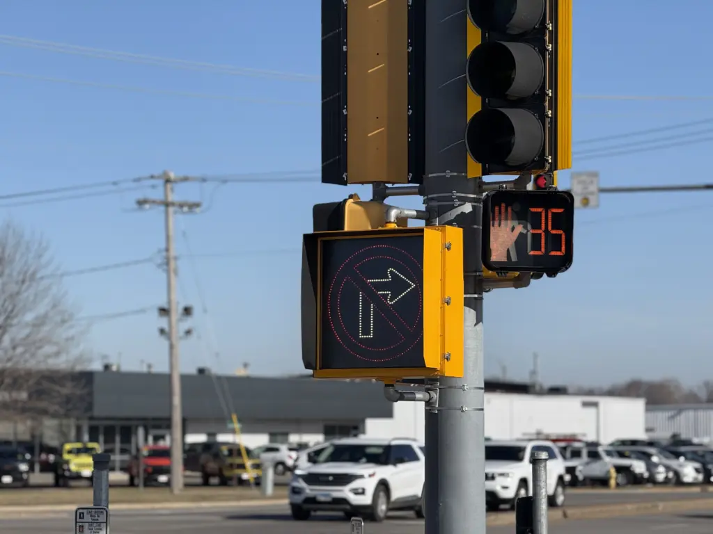 Traffic signal displaying "No Right Turn on Red" at Carl Sandburg Drive and North Henderson Street intersection