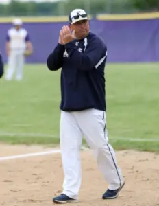 Coach Rick Reed clapping encouragement on the Knoxville baseball field