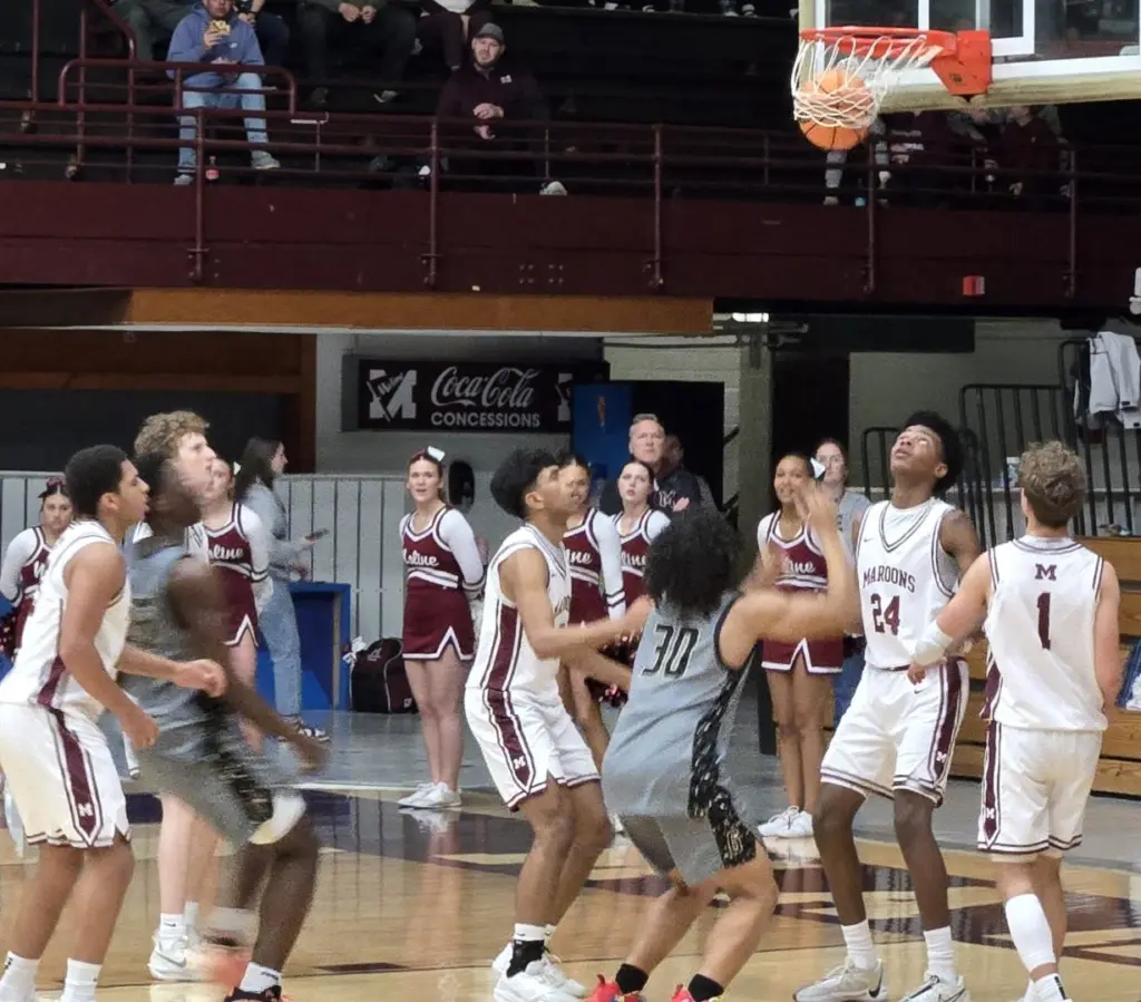GHS and Moline players under the basket watching a shot go through the net.