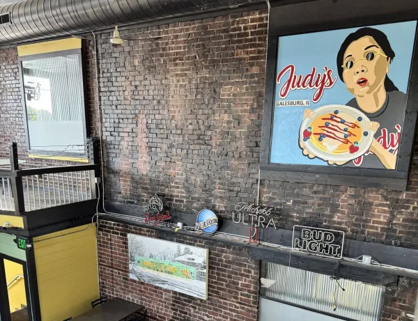 Interior view of Judy's Kitchen in downtown Galesburg, highlighting the seating area beneath the mural that will be converted into a new open kitchen for breakfast production.