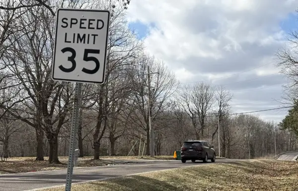 35 mph speed limit sign on South Lake Storey Road in Galesburg, Illinois, with a vehicle approaching, highlighting traffic concerns on the road.