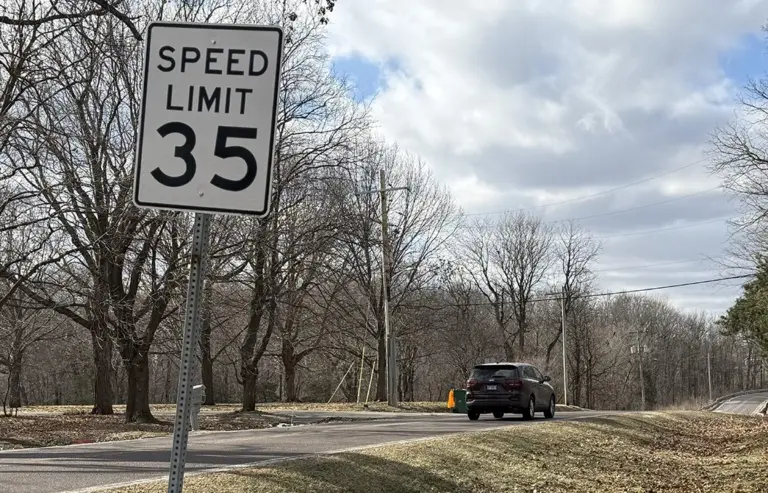 35 mph speed limit sign on South Lake Storey Road in Galesburg, Illinois, with a vehicle approaching, highlighting traffic concerns on the road.