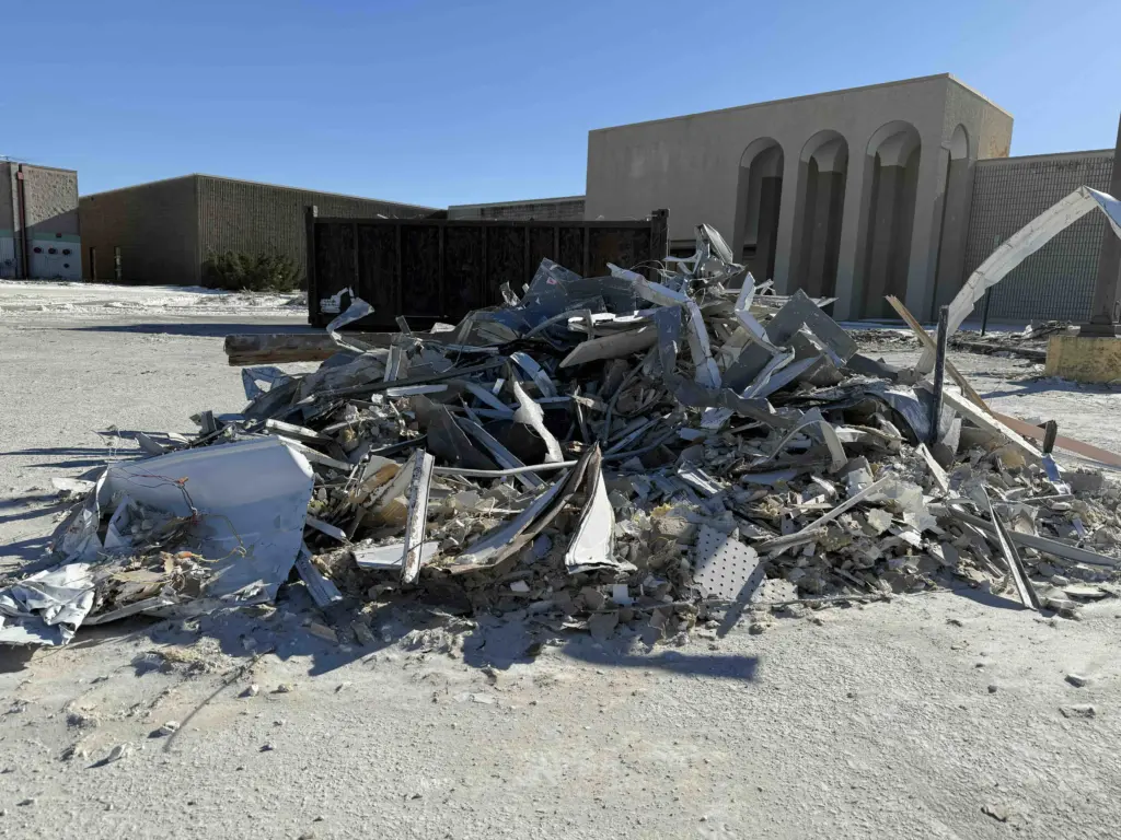 Large pile of construction debris outside the former Sears building at Sandburg Mall in Galesburg