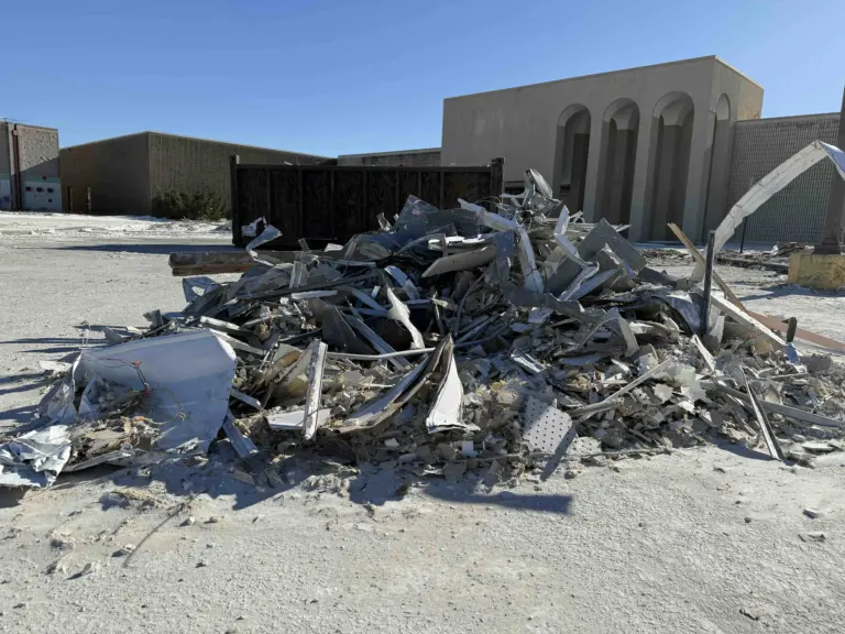Large pile of construction debris outside the former Sears building at Sandburg Mall in Galesburg