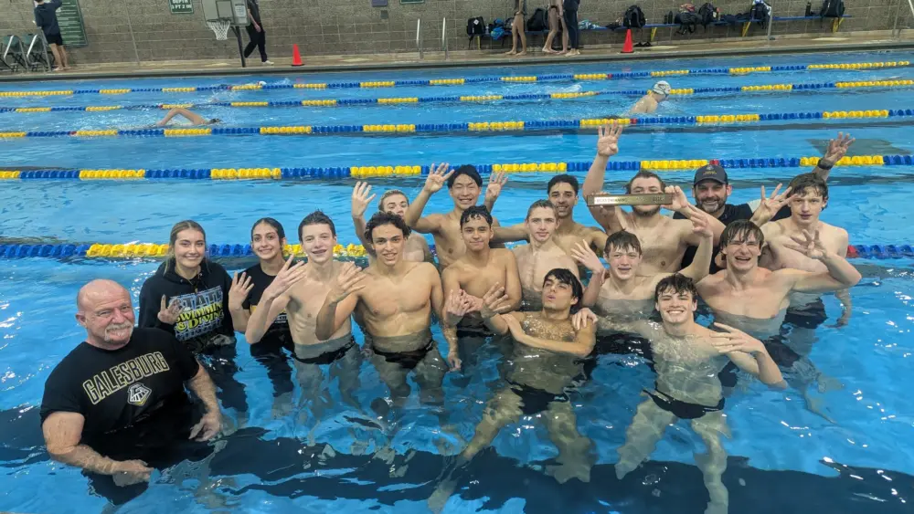Galesburg High School boys swimming and diving team celebrates fourth straight Western Big 6 Conference championship Saturday at Sterling High School.