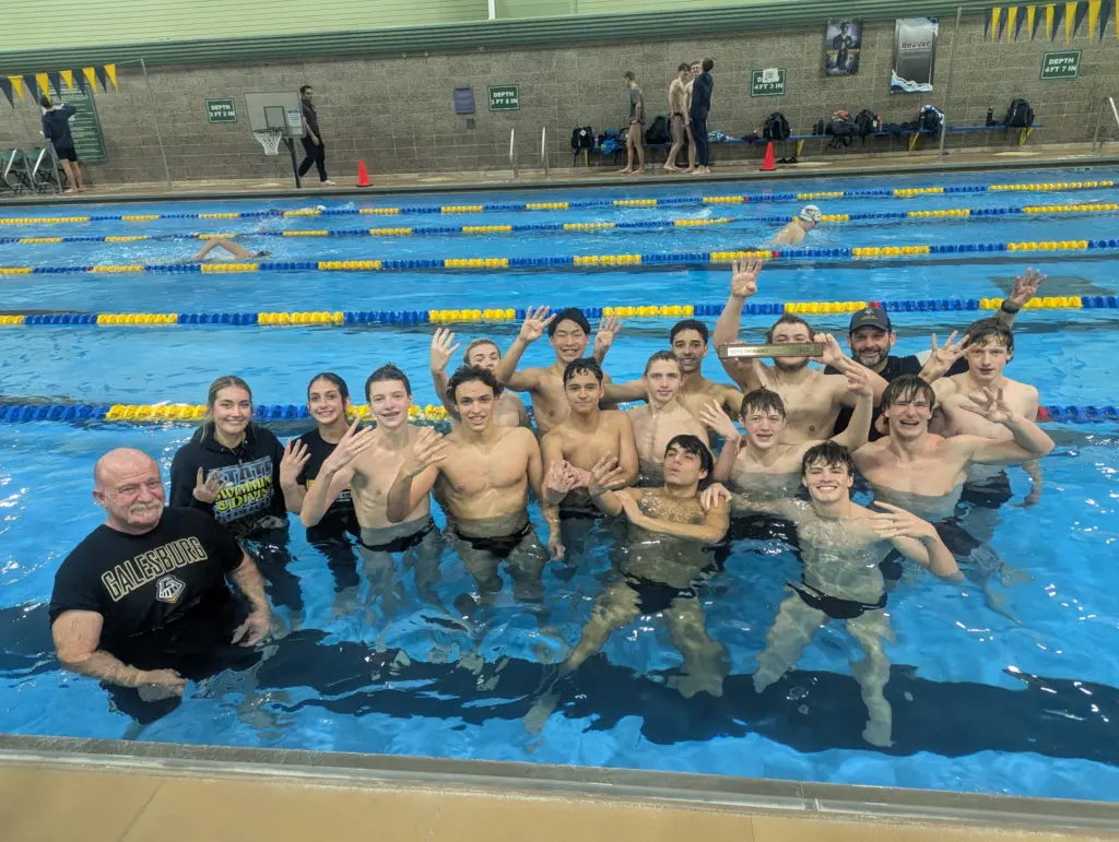 Galesburg High School boys swimming and diving team celebrates fourth straight Western Big 6 Conference championship Saturday at Sterling High School.