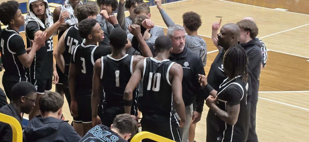 GHS boys basketball team huddle during game at Sterling. February 2026
