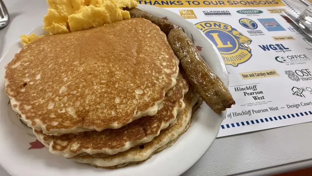 Stack of pancakes with eggs and sausage from Galesburg Lions Club Pancake Day