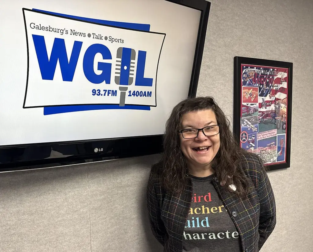 Jill Bradford standing in front of the WGIL sign in the studio