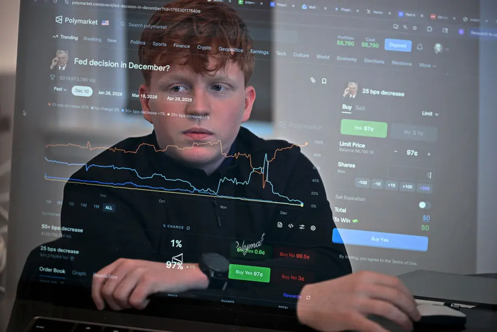 University of Chicago freshman Oliver Wilson analyzes interest rates bets on the Polymarket prediction market platform in his Hyde Park apartment late last year. Polymarket CEO Shayne Coplan has pledged $20,000 to kickstart Wilson’s prediction market club at his university. (Credit: Victor Hilitski/For Illinois Answers Project)