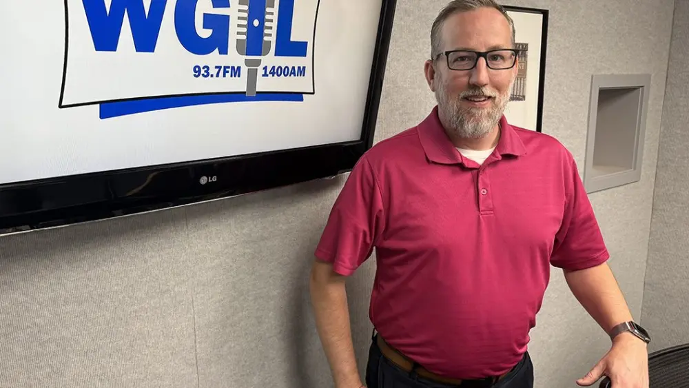 Alt: Knox County Board Chairman Jared Hawkinson standing in the WGIL studio