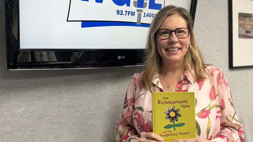 Author Trinette Olin holds her debut children's novel at WGIL in Galesburg, Illinois, April 24, 2026.