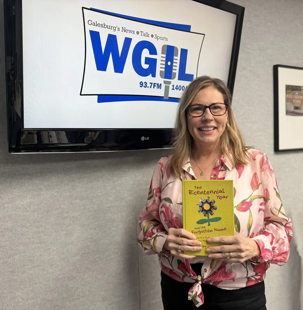 Author Trinette Olin holds her debut children's novel at WGIL in Galesburg, Illinois, April 24, 2026.