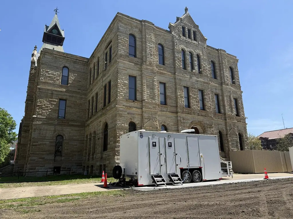 Portable restroom trailer parked outside the west entrance of the Knox County Courthouse in Galesburg, Illinois