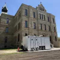 Portable restroom trailer parked outside the west entrance of the Knox County Courthouse in Galesburg, Illinois