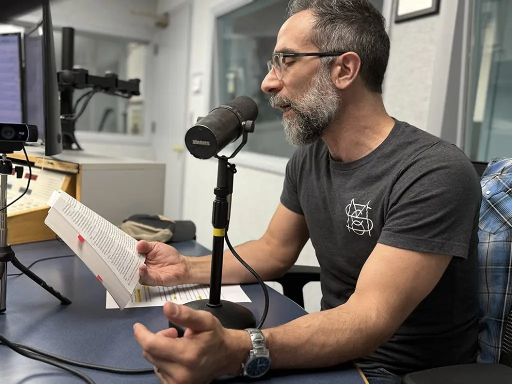 Nicholas Regiacorte reading from Kaveh Akbar's novel Martyr at the WGIL studios, May 19, 2026
