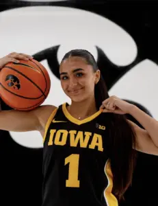 Bria Medina in an Iowa Hawkeyes jersey holding a basketball during her official visit — May 2026