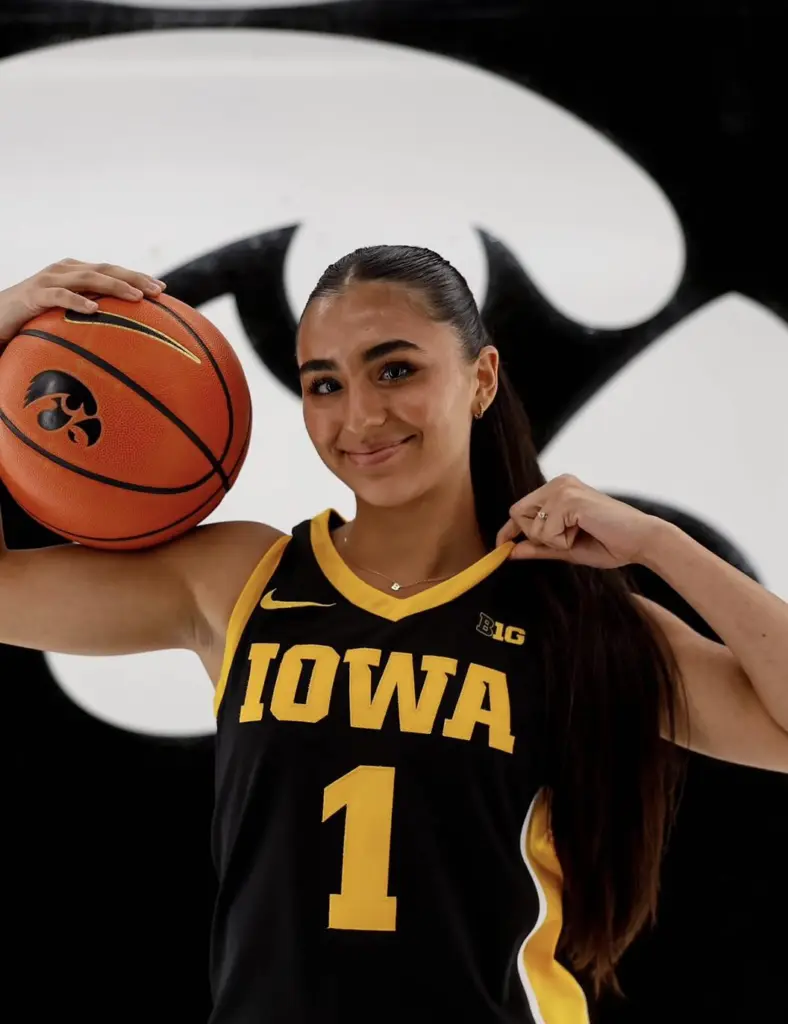 Bria Medina in an Iowa Hawkeyes jersey holding a basketball during her official visit — May 2026
