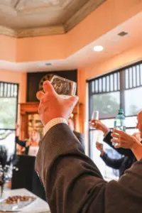 Guests raise a toast at the Discovery Depot 30th anniversary reception at Innkeeper's Fresh Roasted Coffee in Galesburg