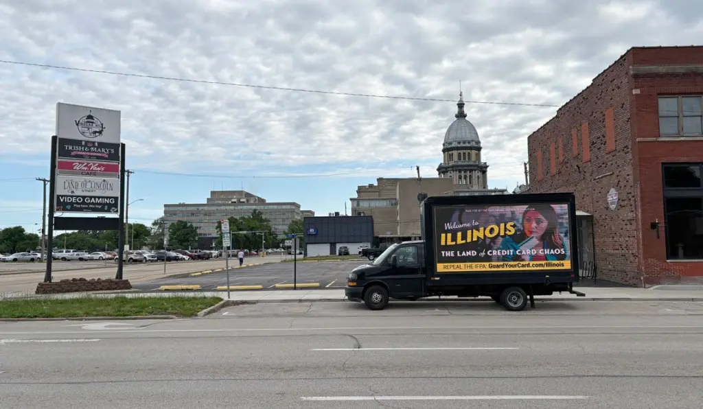 A “Credit Card Chaos” ad appears on a drivable billboard a few blocks from the Illinois Capitol during the legislature’s final stretch. The Illinois law that it targets suffered a pair of setbacks this week.