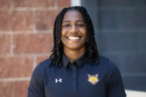 Akyia Baker, Knox College women's flag football coach, in a Prairie Fire polo shirt
