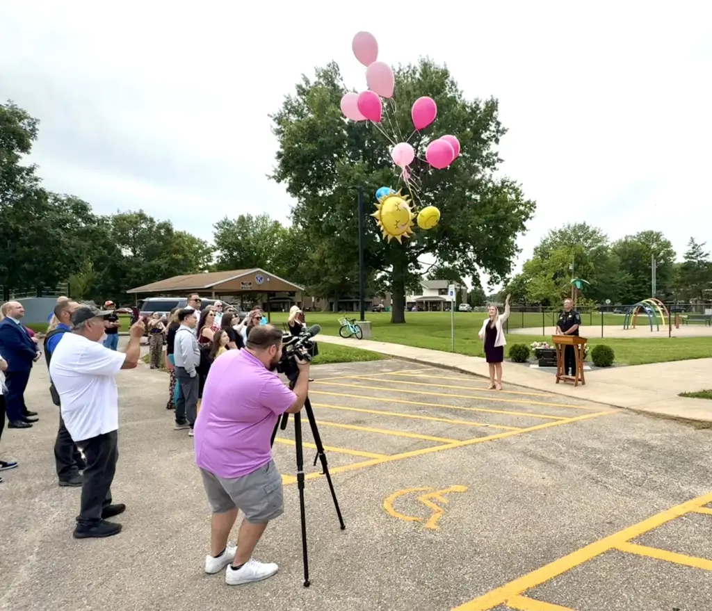 Knox County State's Attorney Ashley Worby releases 13 balloons at the Willow Banks memorial bench dedication at Kiwanis Park in Galesburg — June 25, 2026