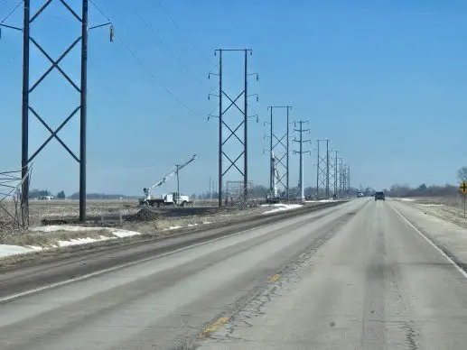 Utility crews and transmission towers under construction along U.S. Highway 34 in Knox County
