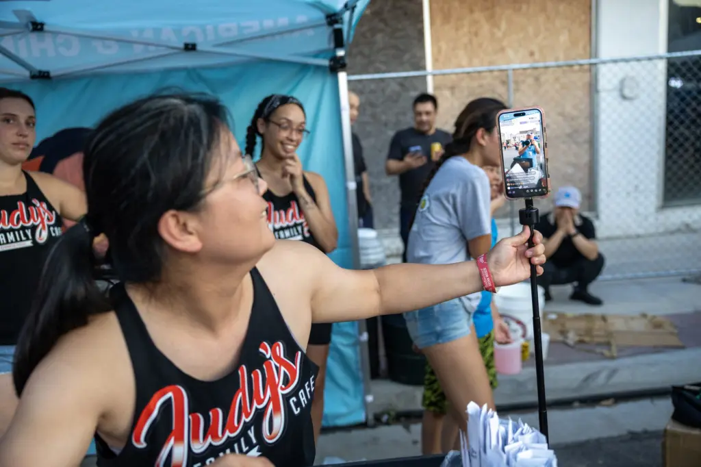 Judy's Kitchen employee filming a livestream at Taste of Galesburg
