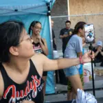 2026 Taste of Galesburg: Judy Wang and the Judy's Kitchen crew livestreams from their booth at the 40th Taste of Galesburg, Thursday, July 16, 2026. (Photo courtesy STEVE DAVIS/SeedCo Media)