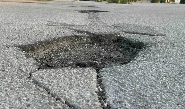Cracked and crumbling pavement in a Galesburg parking lot