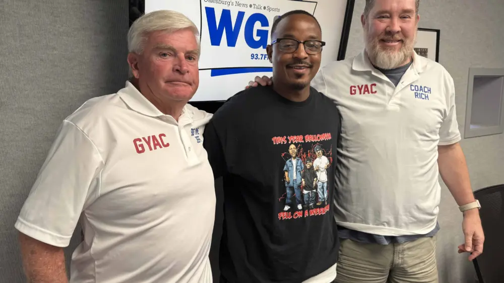 Jeff Hoschek, Terrence Gregory, and Rich Norton of the Galesburg Youth Athletic Club standing together in the WGIL studio.