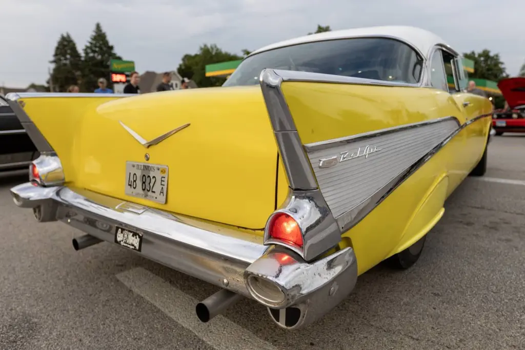 Rear view of a yellow 1957 Chevrolet Bel Air at a past Maple City Street Machines Cruise-In in Monmouth.