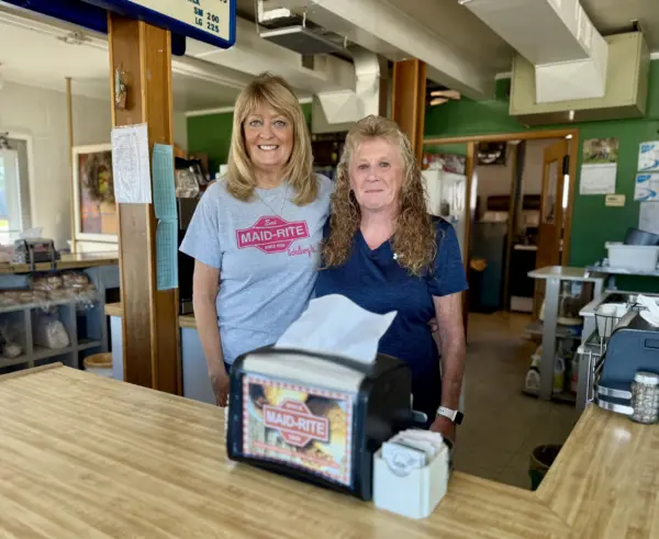 Becky Willer and Chery Lundeen standing together behind the counter of Red's Sandwich Shop in Galesburg.