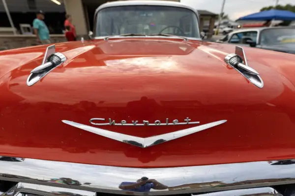 Close-up of a red vintage Chevrolet's hood ornament and grille at a past Maple City Street Machines Cruise-In.