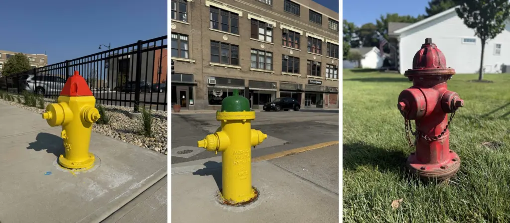 Three Galesburg fire hydrants side by side, showing orange, green, and red color-coded tops.