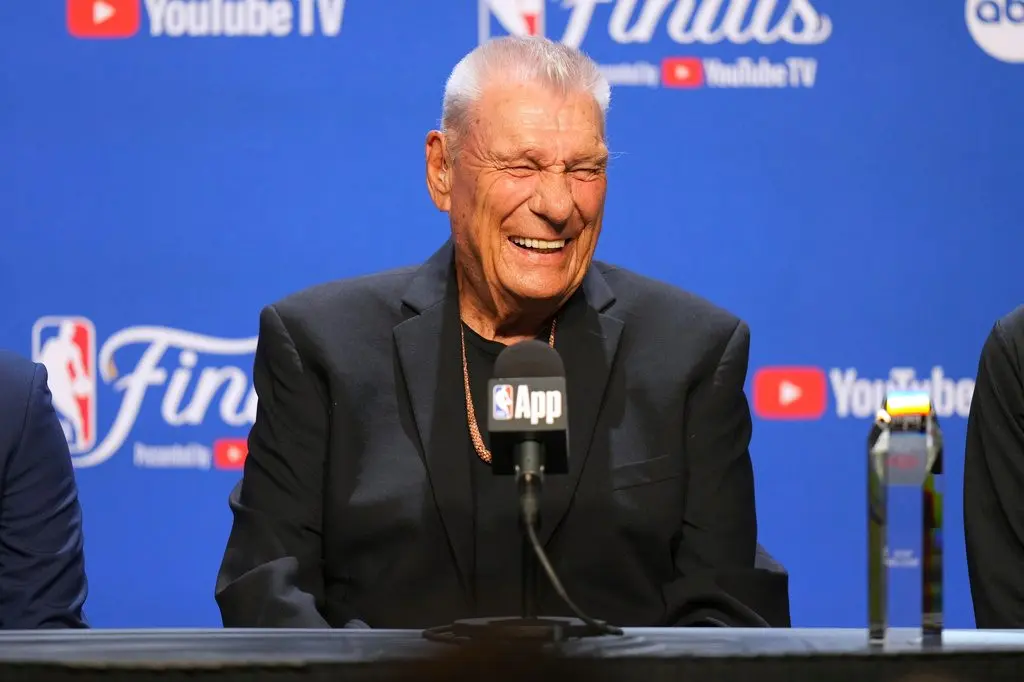 Don Nelson laughing at a podium microphone in front of an NBA Finals backdrop (AP Photo/Kyle Phillips, File)