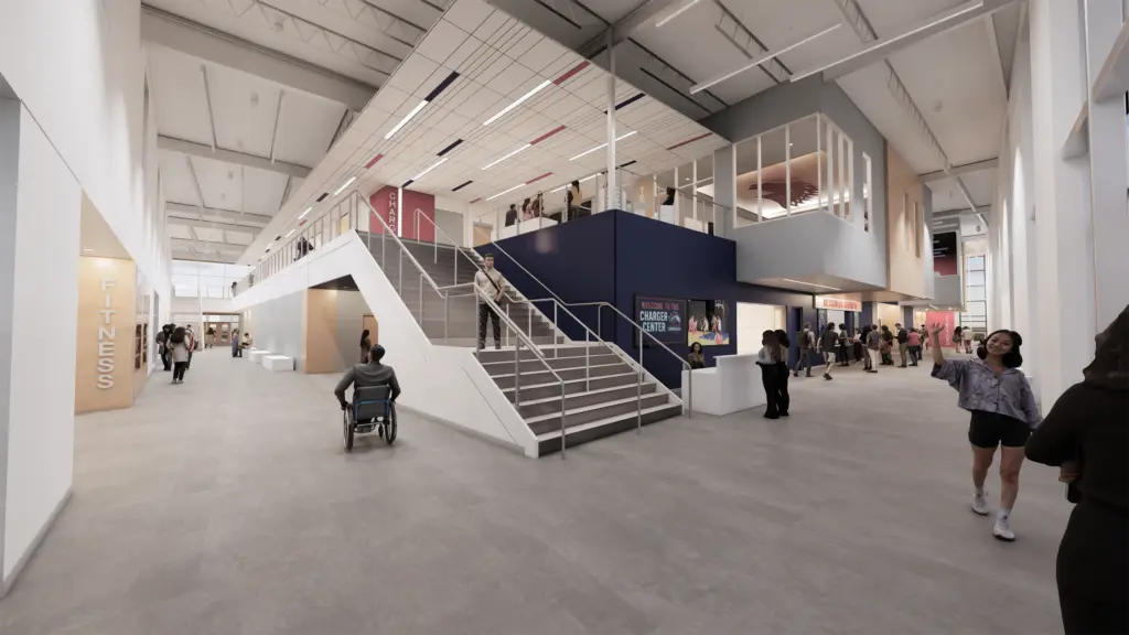 Architectural rendering of a bright two-story lobby with a staircase and Charger Center signage