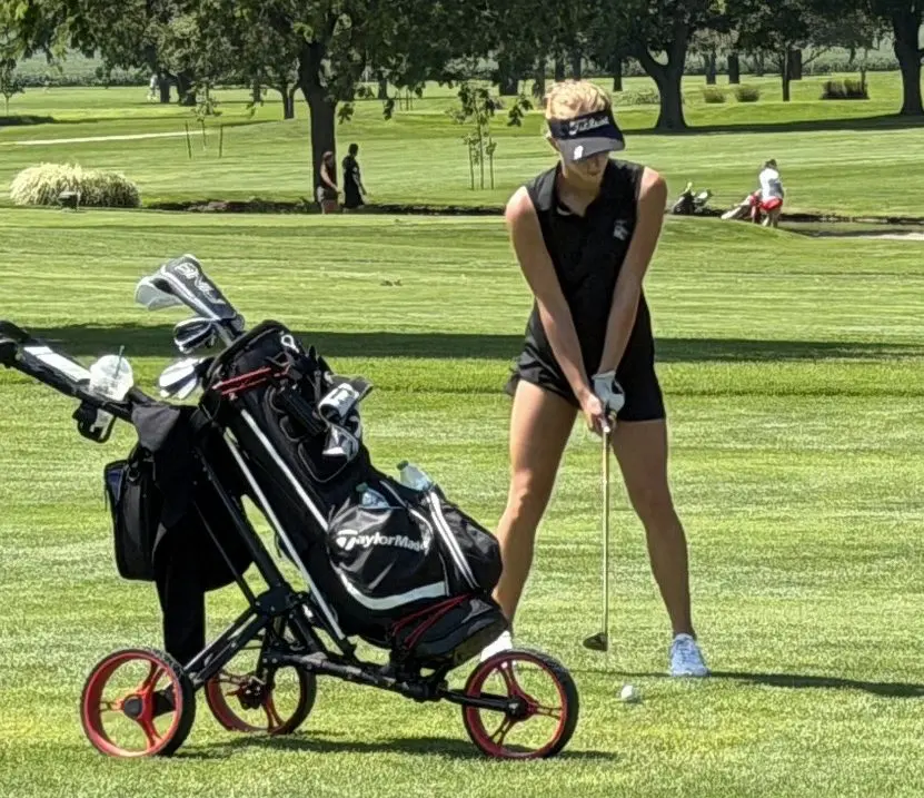 Ella Herchenroder addresses the ball during a golf tournament