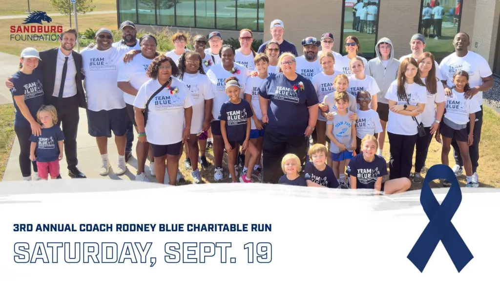 Group of runners and walkers wearing Team Blue shirts for the Coach Rodney Blue Charitable Run