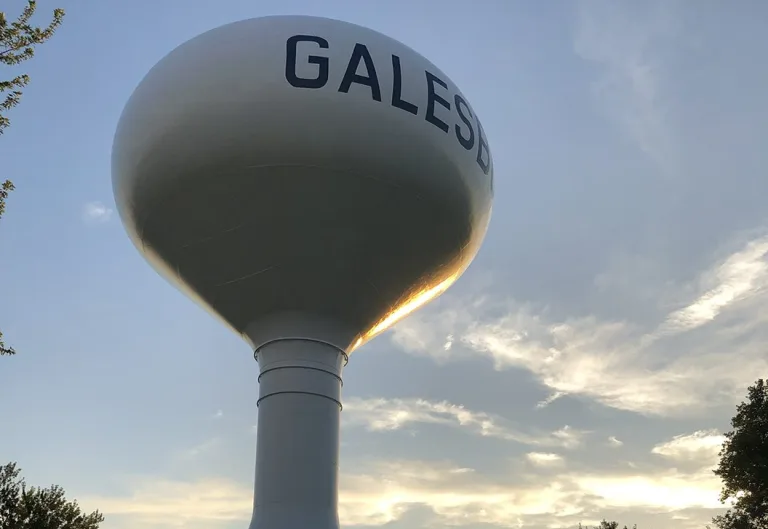 Galesburg water tower against a sunset sky