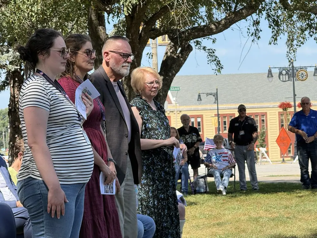 Kyle Wehrly's daughter, wife, father and mother standing together during the dedication ceremony