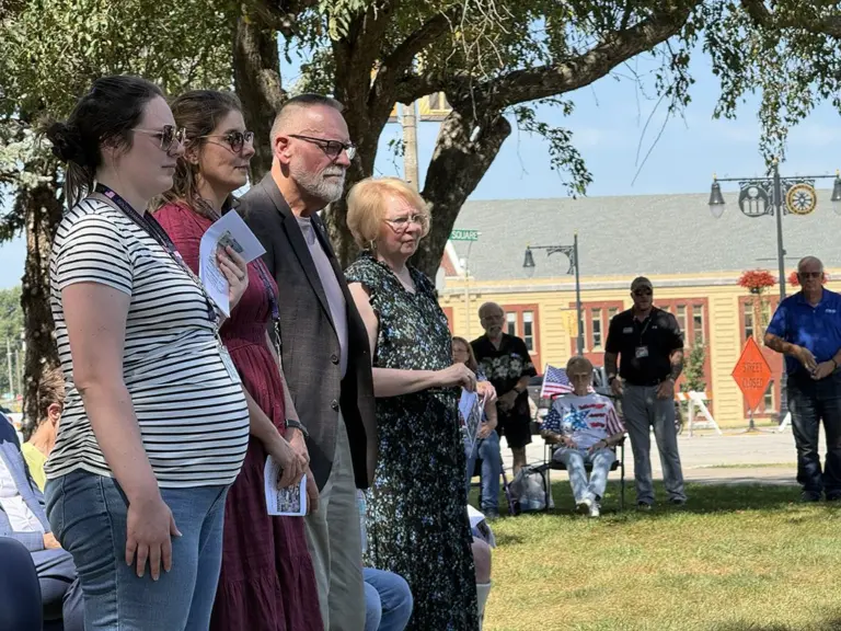 Kyle Wehrly's daughter, wife, father and mother standing together during the dedication ceremony
