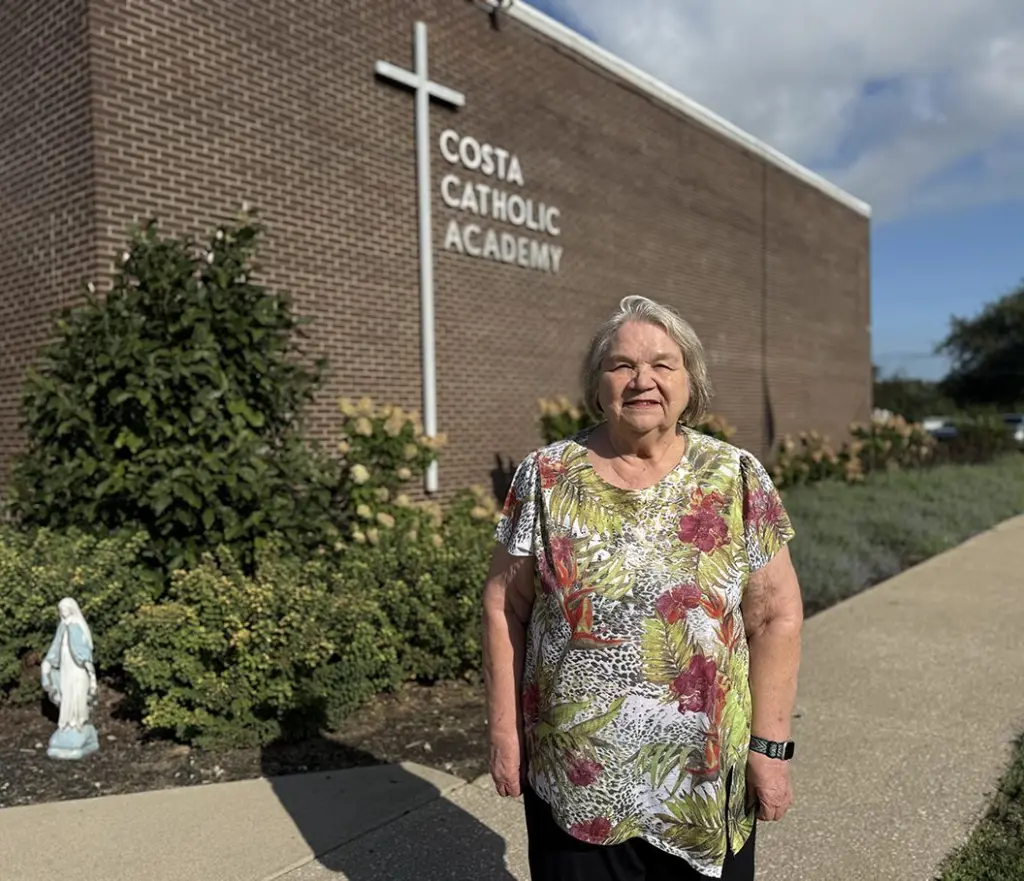 Mary Norton standing outside Costa Catholic Academy in Galesburg, Illinois