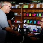 barry-swanson-joe-thompson: Longtime Galesburg basketball official Joe Thompson gets his book signed while chatting with Barry Swanson at Wednesday's signing at Wordsmith Bookshoppe. (Photo courtesy Tom Foley)
