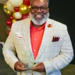 anthony-law-five-over-40-2026: Anthony Law III, of Carl Sandburg College's Student Development office, holds his 2026 Five Over 40 award at the Galesburg Area Chamber of Commerce's Evening of Excellence. (Photo provided)
