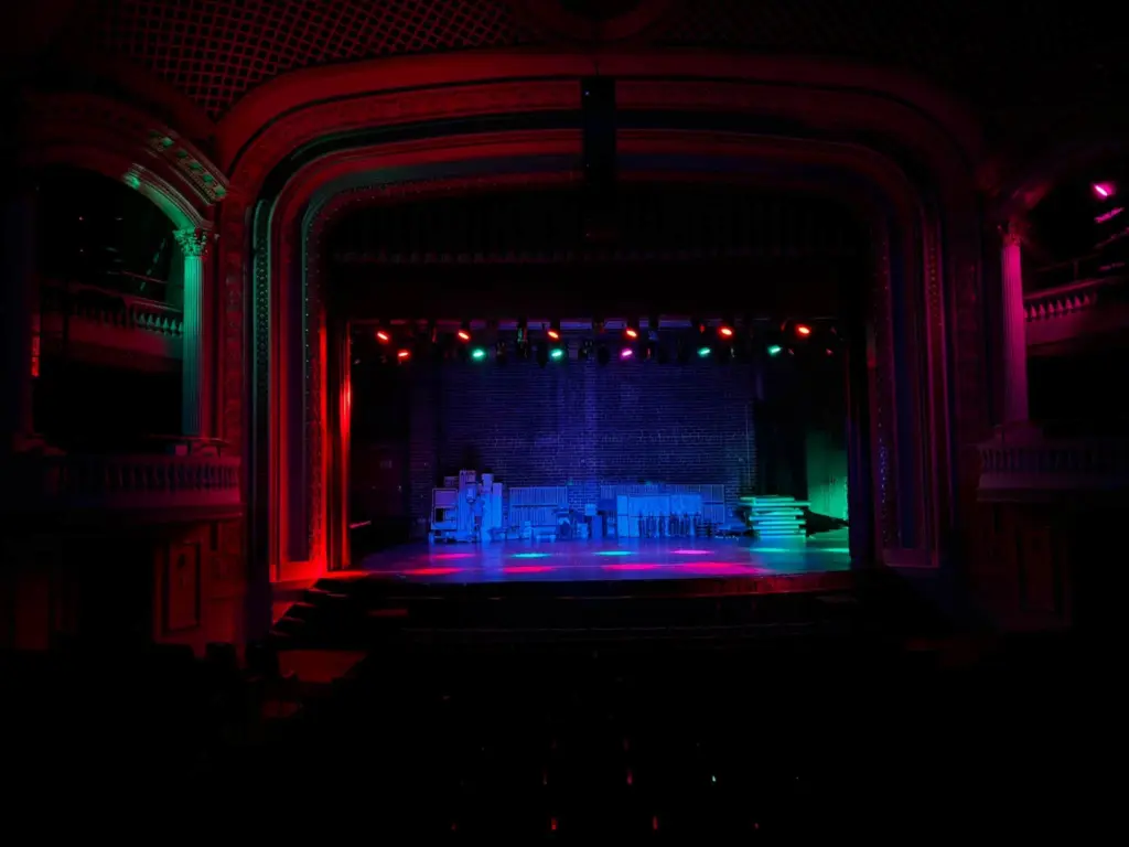 Colored LED stage lights glow red, green and blue above the stage of the ornate Orpheum Theatre