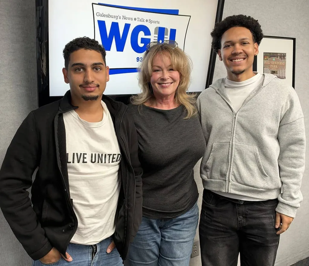 Diego dos Santos Branco Martinez, Jeannie Weber, and Caio Oliveira stand in front of a WGIL logo screen in the station's studio